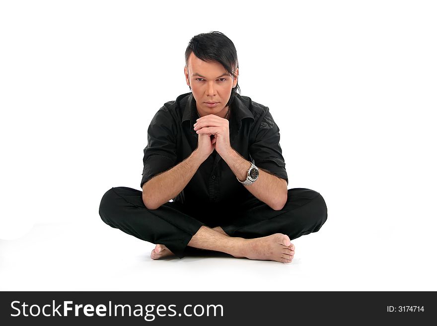 Young attractive man sits in front of camera. Young attractive man sits in front of camera