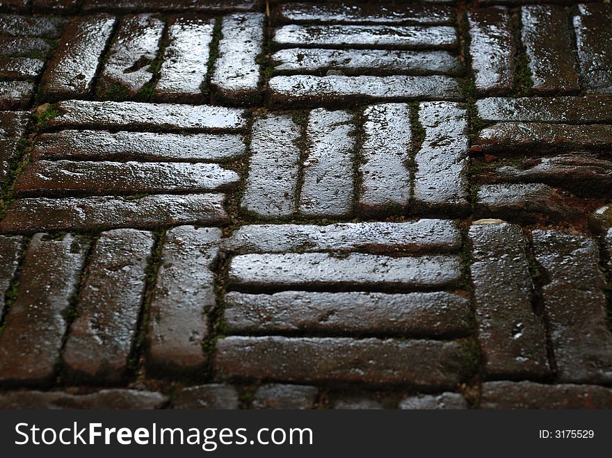 A close-up image of a wet stone side walk in thailand. A close-up image of a wet stone side walk in thailand