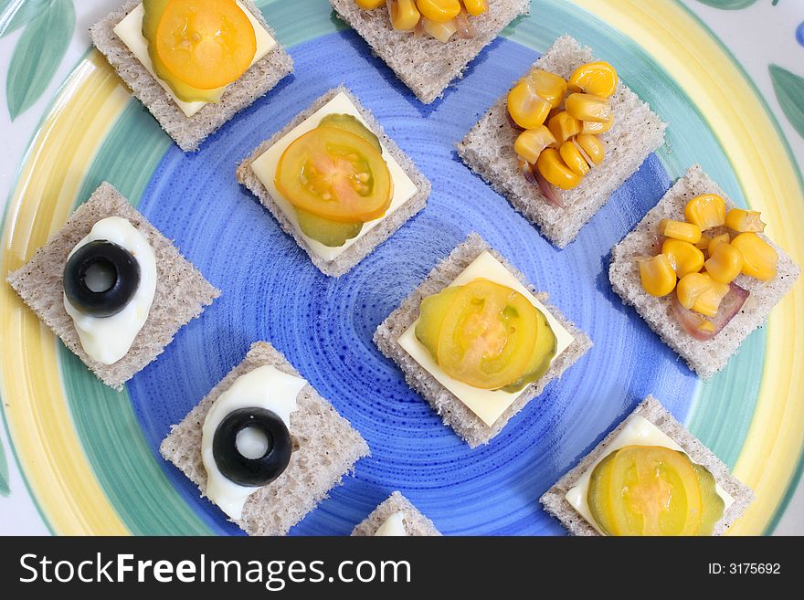 Fruit and vegetable canapes on a white ceramic plate