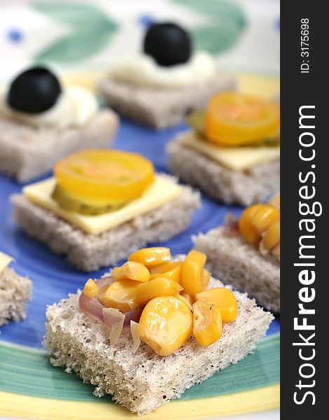 Fruit and vegetable canapes on a white ceramic plate