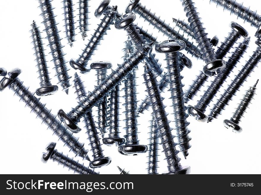 Macro Close-Up Of Spiral Metal Screws On A White Background