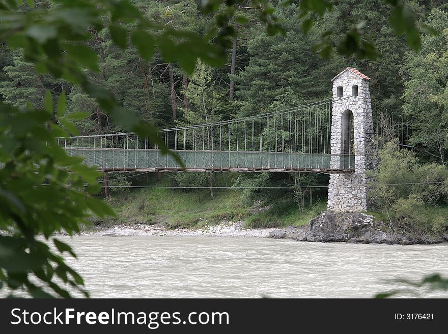 Suspension bridge over the river in austrian Alps