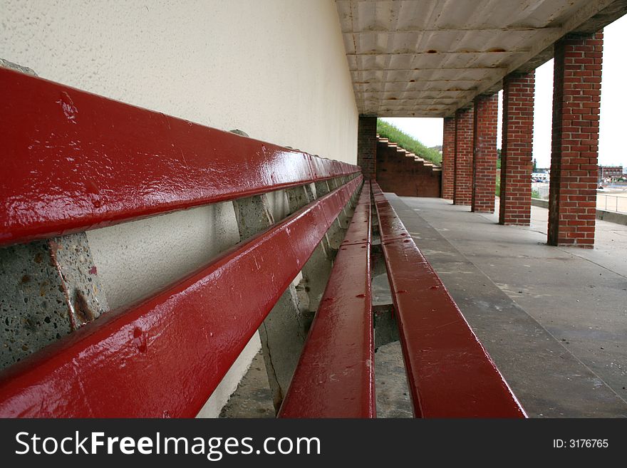 Long wooden Red Beach Bench. Long wooden Red Beach Bench