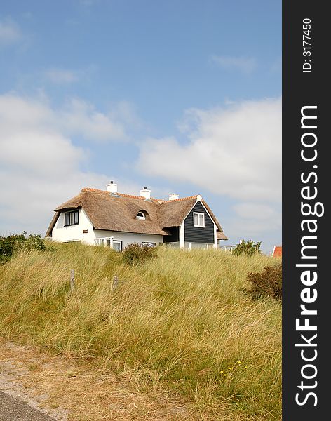 Farm house is standing in grass dunes