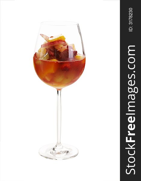 Fruit cocktail in red wine glass over a white background (isolated)