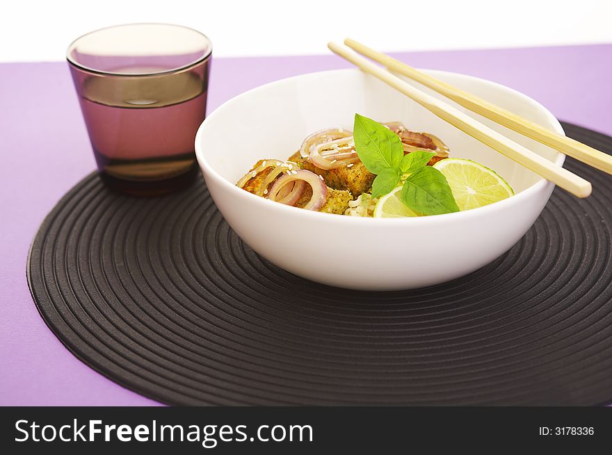 Asian style noodles and deep fried fish on purple background. Asian style noodles and deep fried fish on purple background