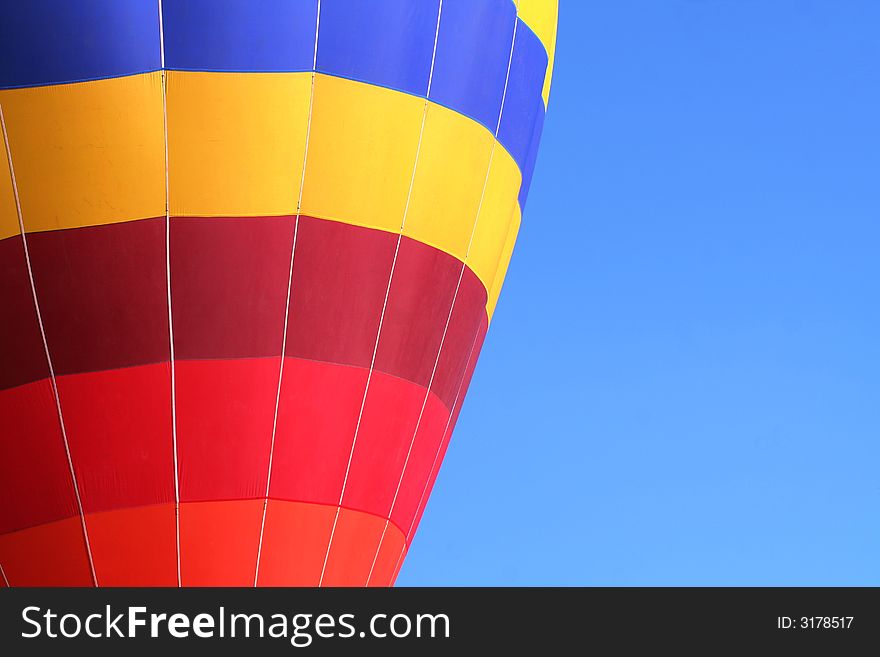 Colorful dirigible on blue sky background