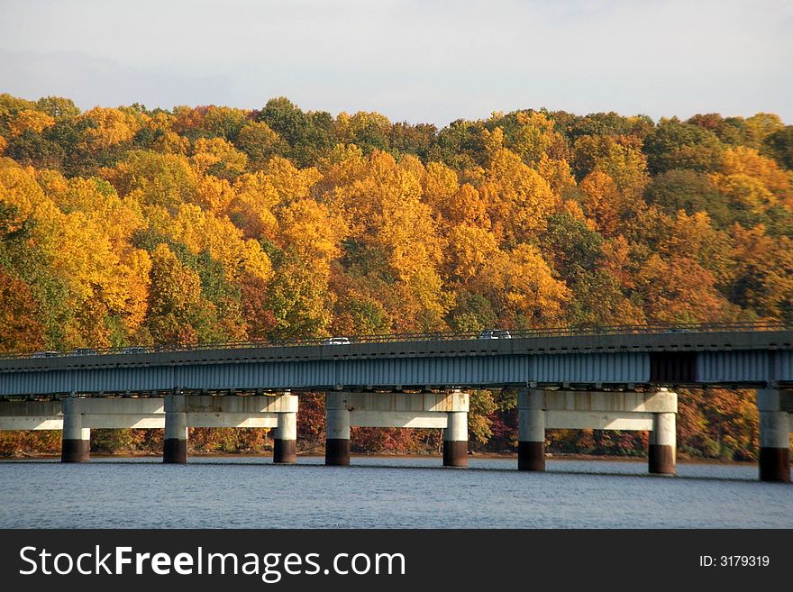 Fall foliage, water and bridge