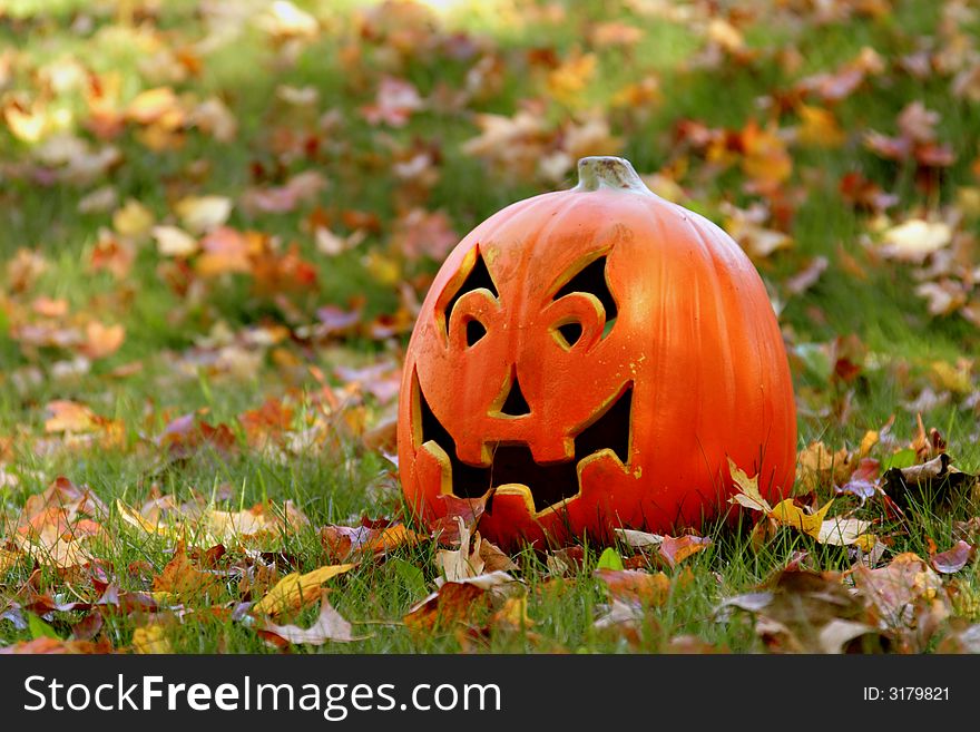 Lone carved pumpkin at the pumpkin patch. Lone carved pumpkin at the pumpkin patch