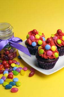 Bright Colored Candy Cupcakes With Candy Jar - Vertical. Royalty Free Stock Images Bright Colored Candy Cupcakes With Candy Jar - Vertical. Royalty Free Stock Images