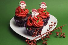 Three Christmas Cupcakes Against A Green Background. Stock Photos Three Christmas Cupcakes Against A Green Background. Stock Photos