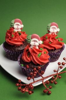 Three Christmas Cupcakes Against A Green Background - Vertical Stock Images