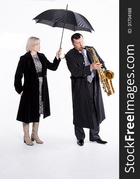 Lone musician and hand girl with an umbrella. Lone musician and hand girl with an umbrella