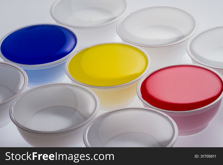 Plastic cups with yellow, blue and red color on white background. Plastic cups with yellow, blue and red color on white background