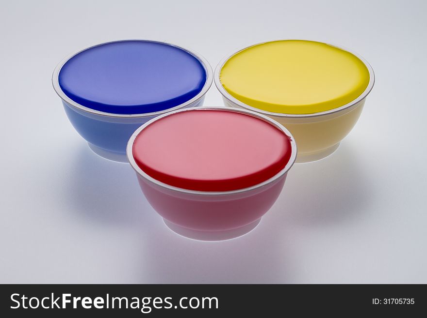 Plastic cups with yellow, blue and red color isolated on a white background. Plastic cups with yellow, blue and red color isolated on a white background