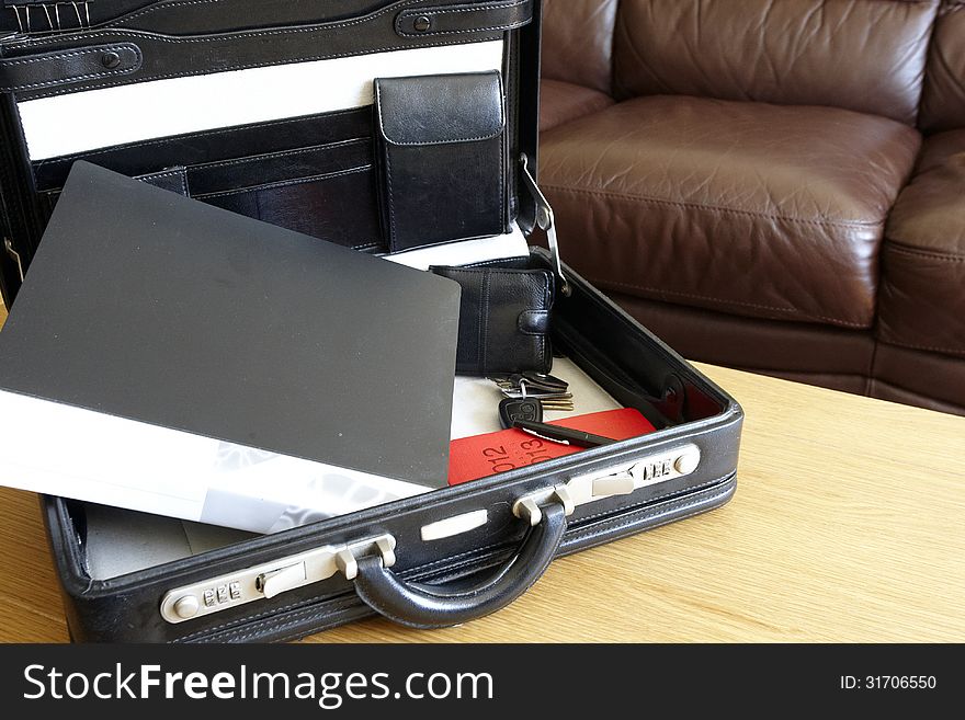 Briefcase, diary and folder with keys and wallet ready for a business meeting. Briefcase, diary and folder with keys and wallet ready for a business meeting