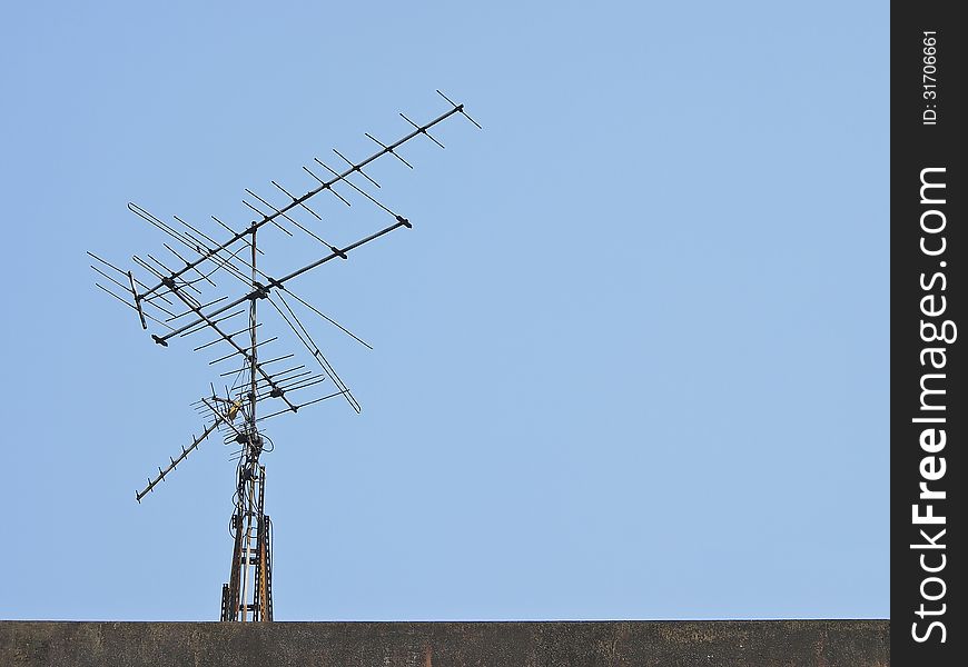 Old receiver tv antenna on top of building. Old receiver tv antenna on top of building