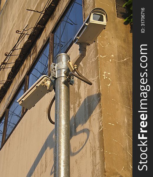 Surveillance cam on pole in building background for security. Surveillance cam on pole in building background for security