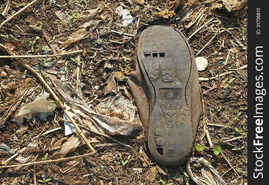 Abandon old canvas shoes on ground in sunlight. Abandon old canvas shoes on ground in sunlight