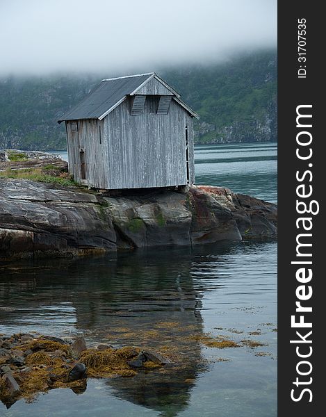 Small old wood cabin by a Norwegian fjord. Small old wood cabin by a Norwegian fjord.