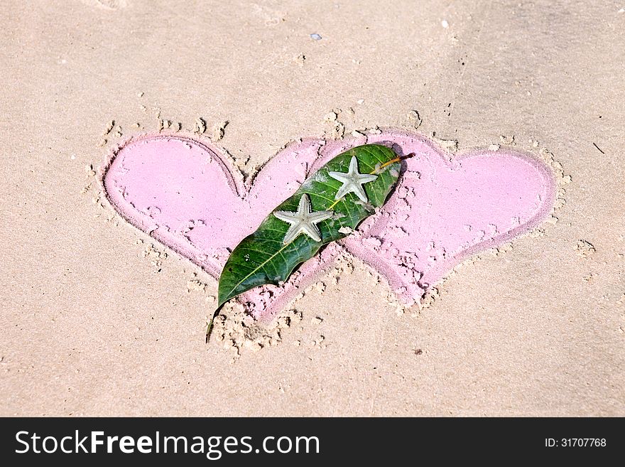 Drawn Hearts And Starfishes On Wet Sand