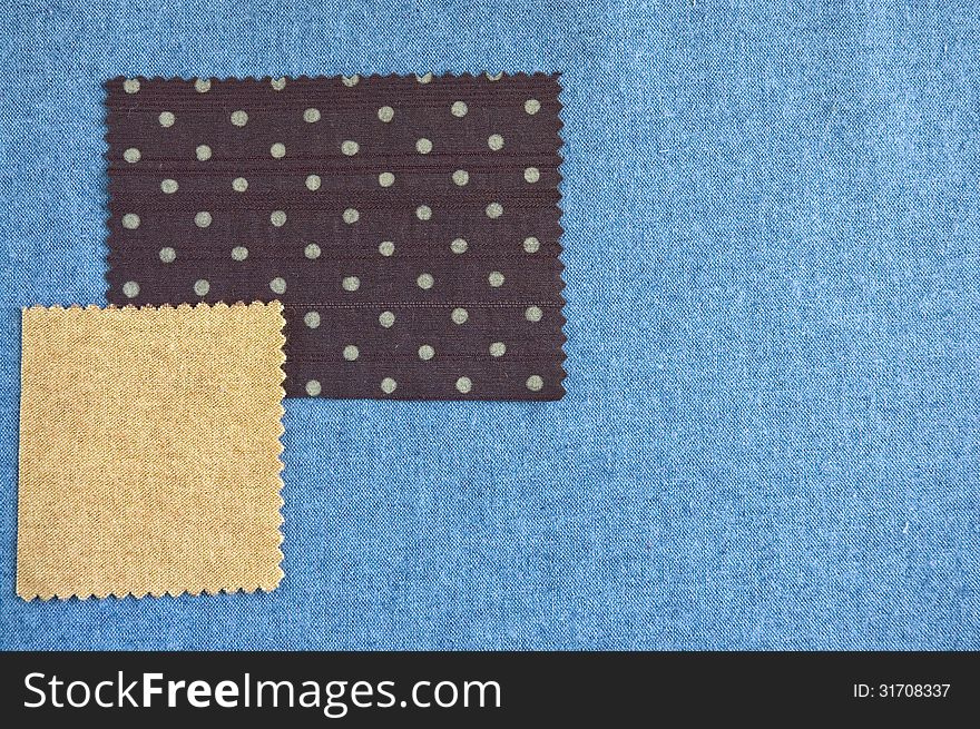 Pieces of fabric brown polka dots and light brown on blue fabric