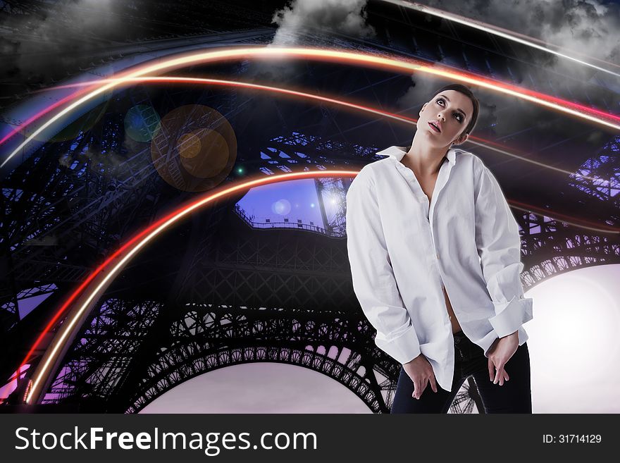 Gorgeous female model standing in pose and looking up dreamy and surprised. Fantastic landscape with cloudy skies, eiffel tower and bridges look like constructions, and colorful light bows in motion as background. Gorgeous female model standing in pose and looking up dreamy and surprised. Fantastic landscape with cloudy skies, eiffel tower and bridges look like constructions, and colorful light bows in motion as background.