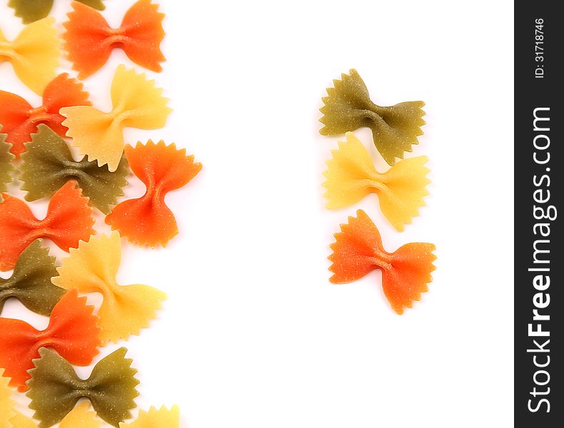 A composition of different pasta in three colors on the white background. A composition of different pasta in three colors on the white background.