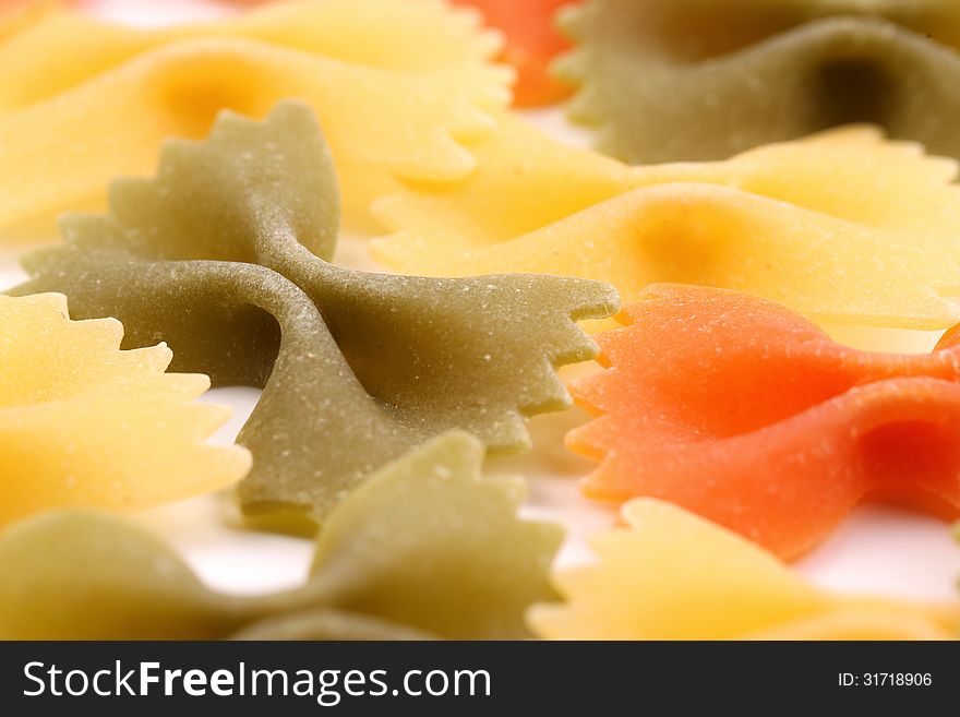 A background of the farfalle pasta three colors close-up.