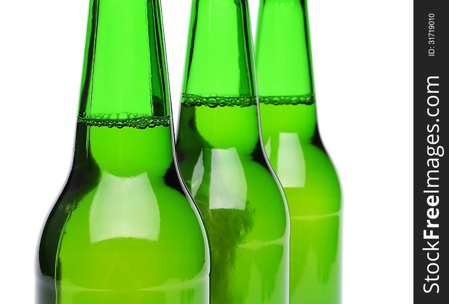 Three bottles of beer close-up on the white backgroun