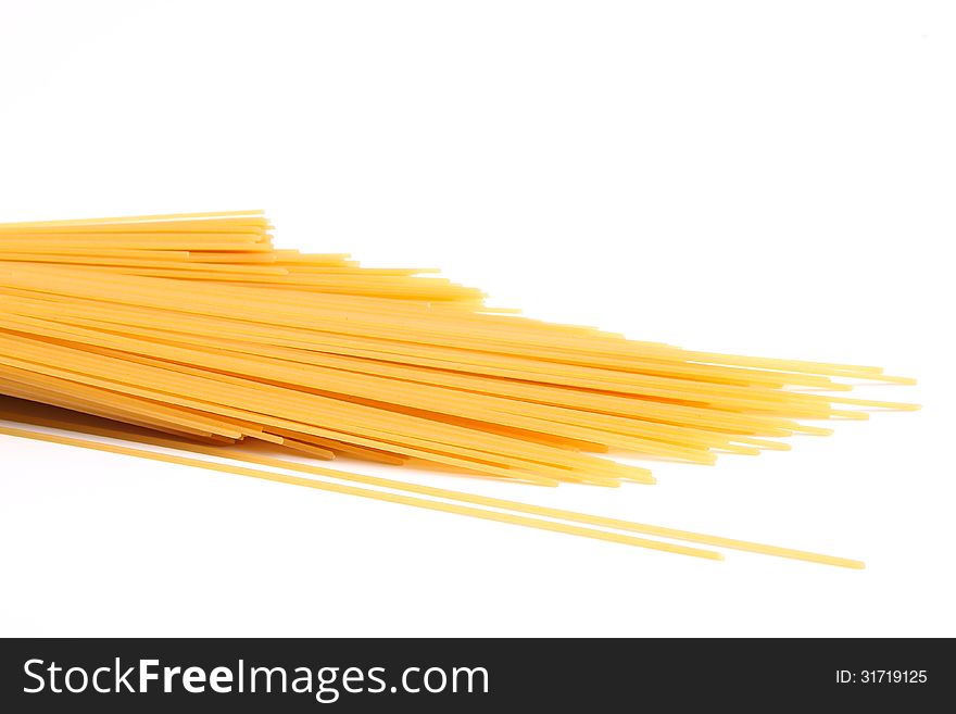 Uncooked spaghetti are located right on a white background. Uncooked spaghetti are located right on a white background