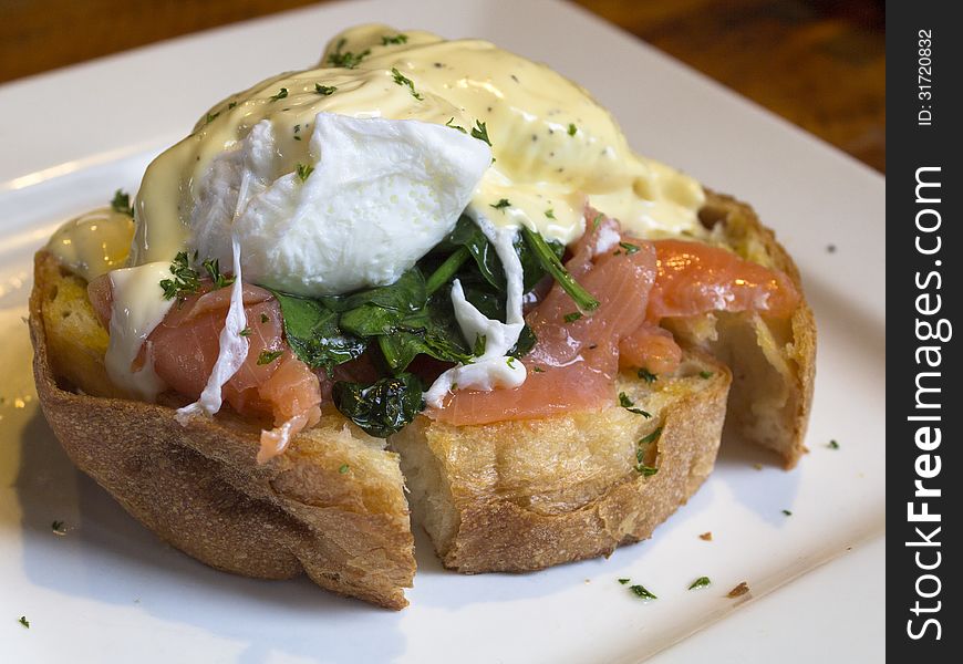 Egg benedict with salmon and spinach close up