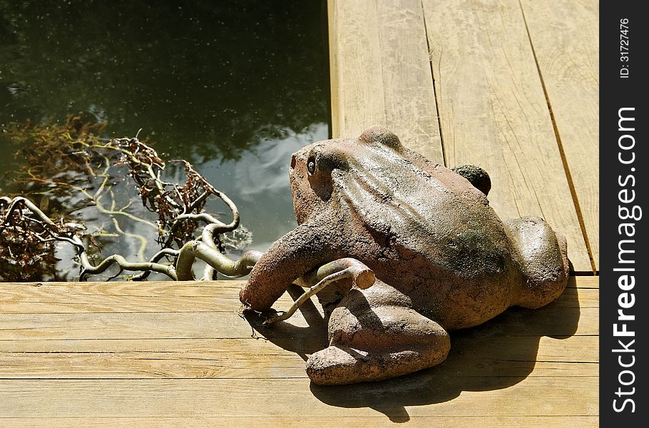Private pond with sculpture of frog. Private pond with sculpture of frog.