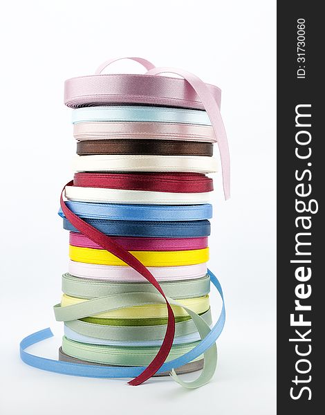 Colorful ribbons, art and craft supplies on white background