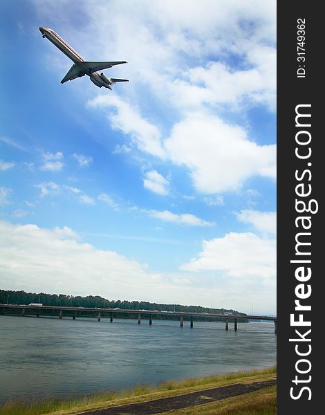 A plane flys over the Glenn Jackson Memorial Bridge connecting Oregon to Government Island and then on to Washington state, spanning the Columbia River. A plane flys over the Glenn Jackson Memorial Bridge connecting Oregon to Government Island and then on to Washington state, spanning the Columbia River