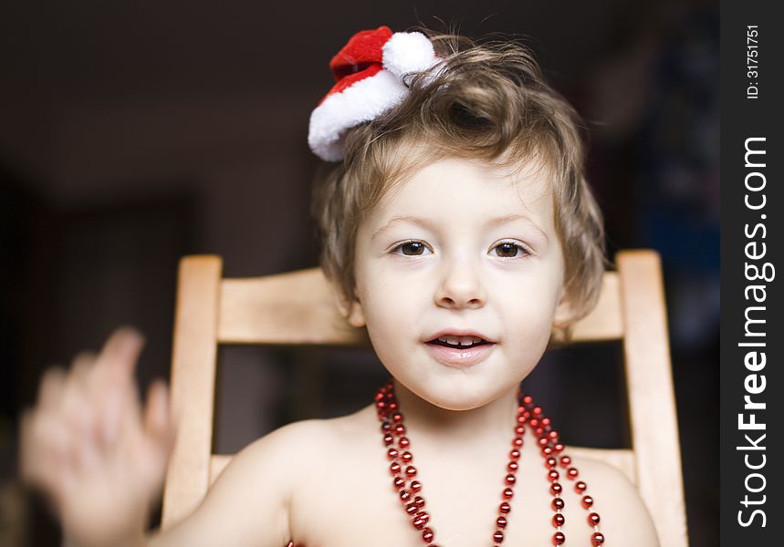 Portrait of little cute boy in Christmas hat