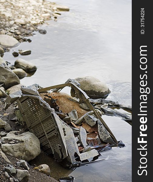 Vertical photo of eroding television dumped in a river. Vertical photo of eroding television dumped in a river