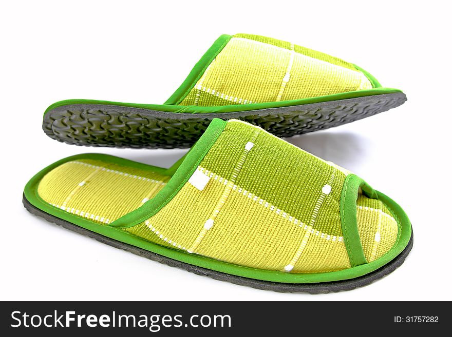 Green cloth slippers on a white background