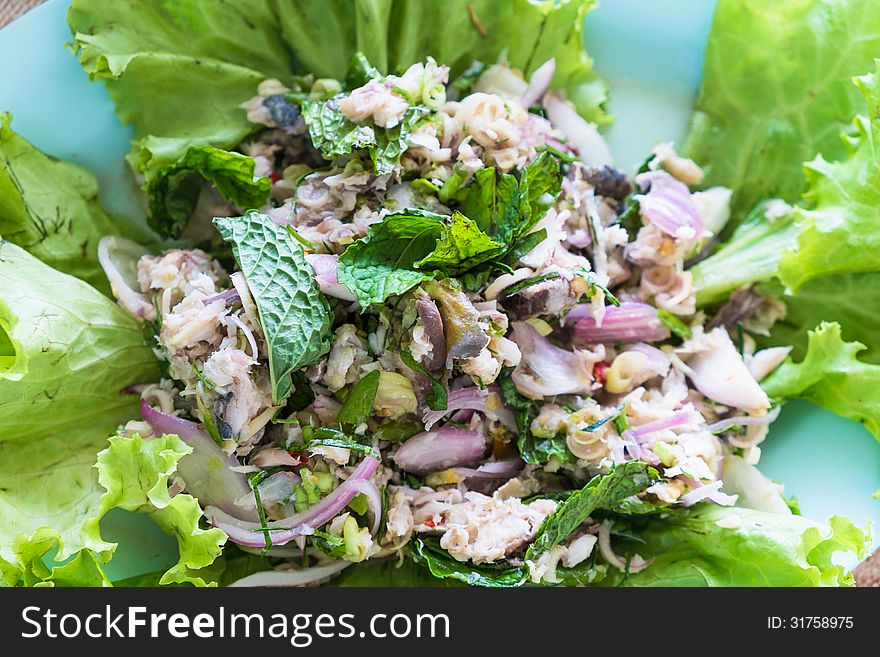 Thai spicy local mackerel fish salad with various local herb and fresh green vegetable. Thai spicy local mackerel fish salad with various local herb and fresh green vegetable