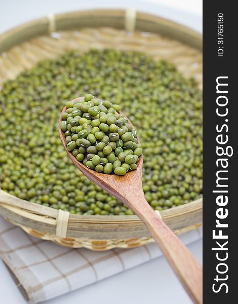 Green mung beans over the wooden spoon