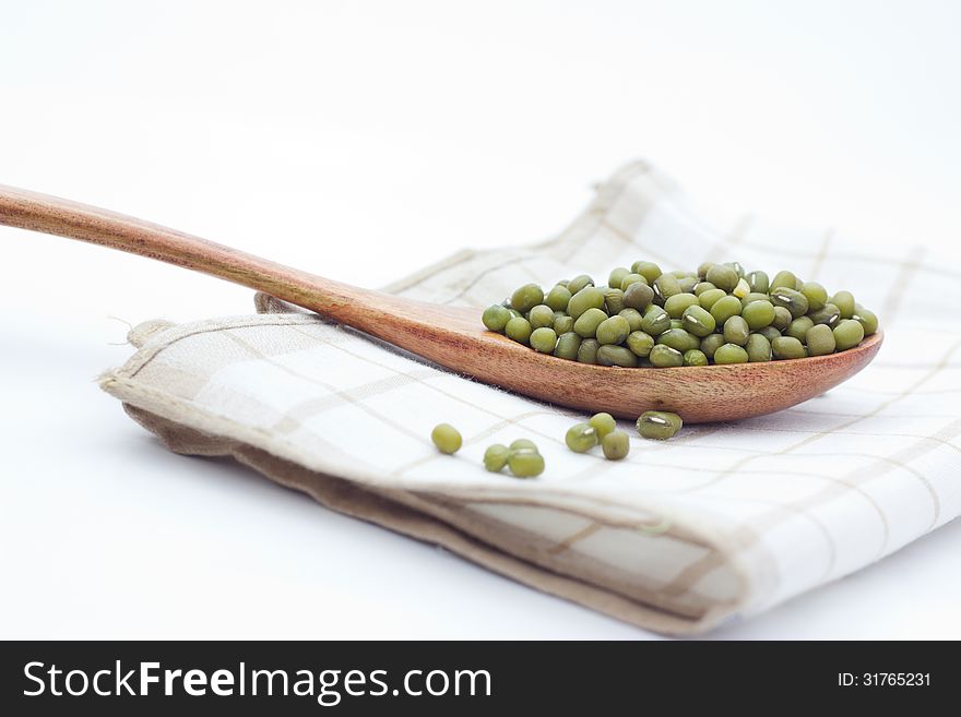 Green mung beans over the wooden spoon