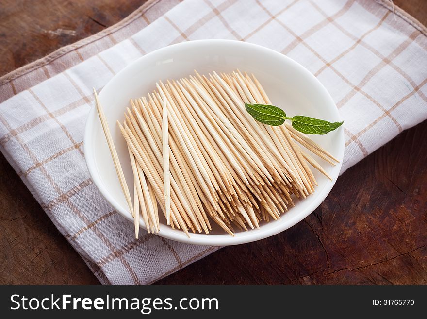 Bamboo skewers in plate on table closeup. Bamboo skewers in plate on table closeup