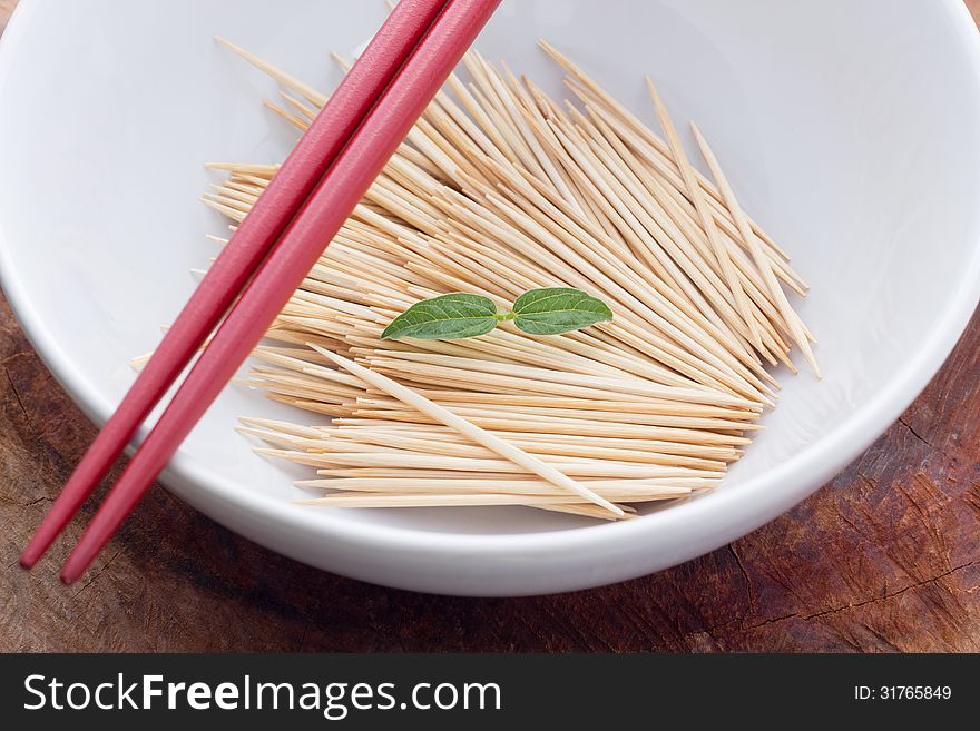 Bamboo skewers in plate on table closeup. Bamboo skewers in plate on table closeup