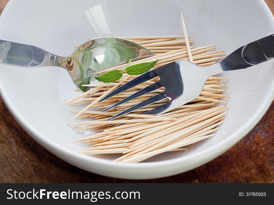 Bamboo skewers in plate on table closeup. Bamboo skewers in plate on table closeup