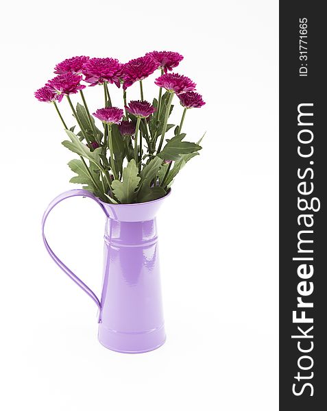 Pink flowers and a purple flagon on a white background.