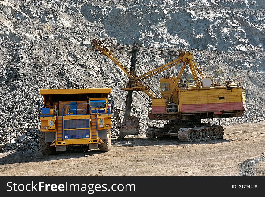 Loading of iron ore on very big dump-body truck