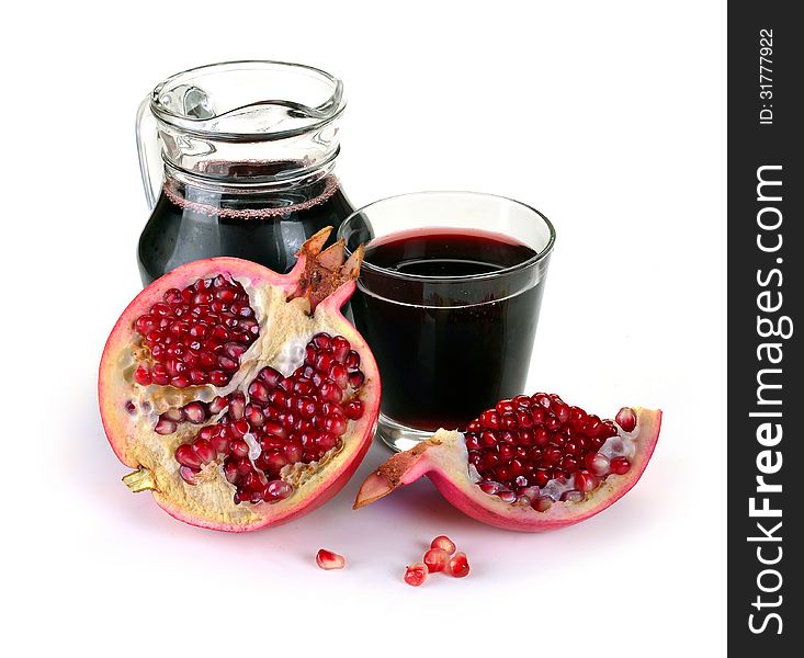 Jug of juice and ripe piece grenade on white background