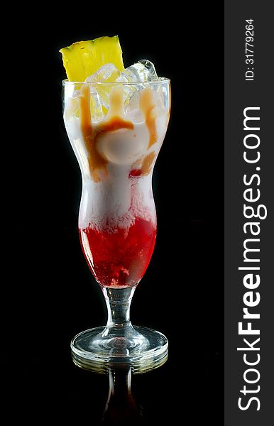 Cocktail with juice and cream on a black background