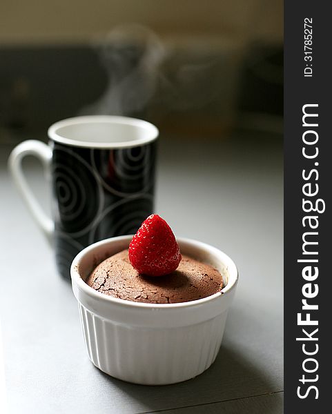 Chocolate dessert with strawberry and cup of tea