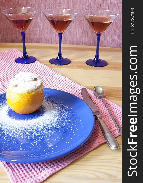 Orange dessert served with a knife, a spoonon and martini glass. Orange dessert served with a knife, a spoonon and martini glass.